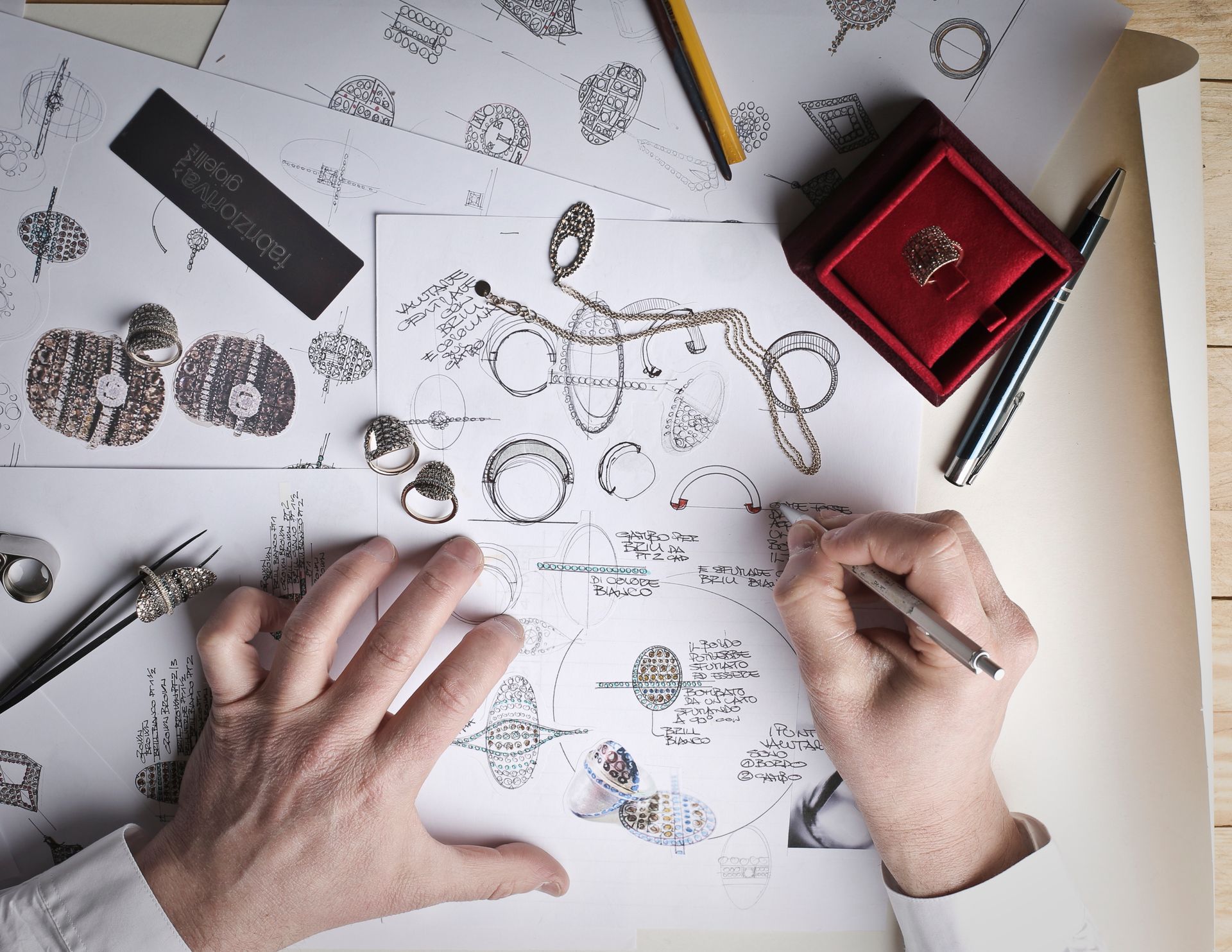 Hand-drawn jewellery design sketches on a designer’s desk