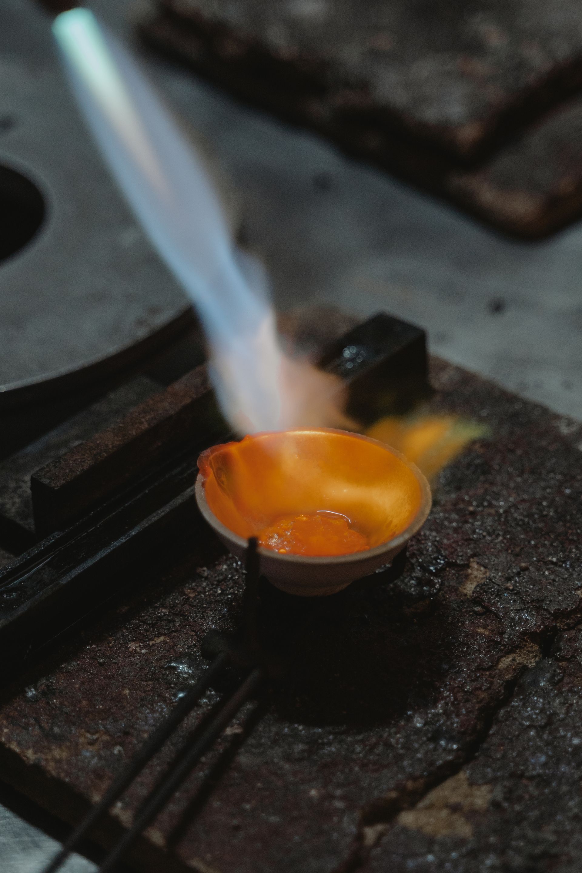 A goldsmith shaping a gold ring at the bench