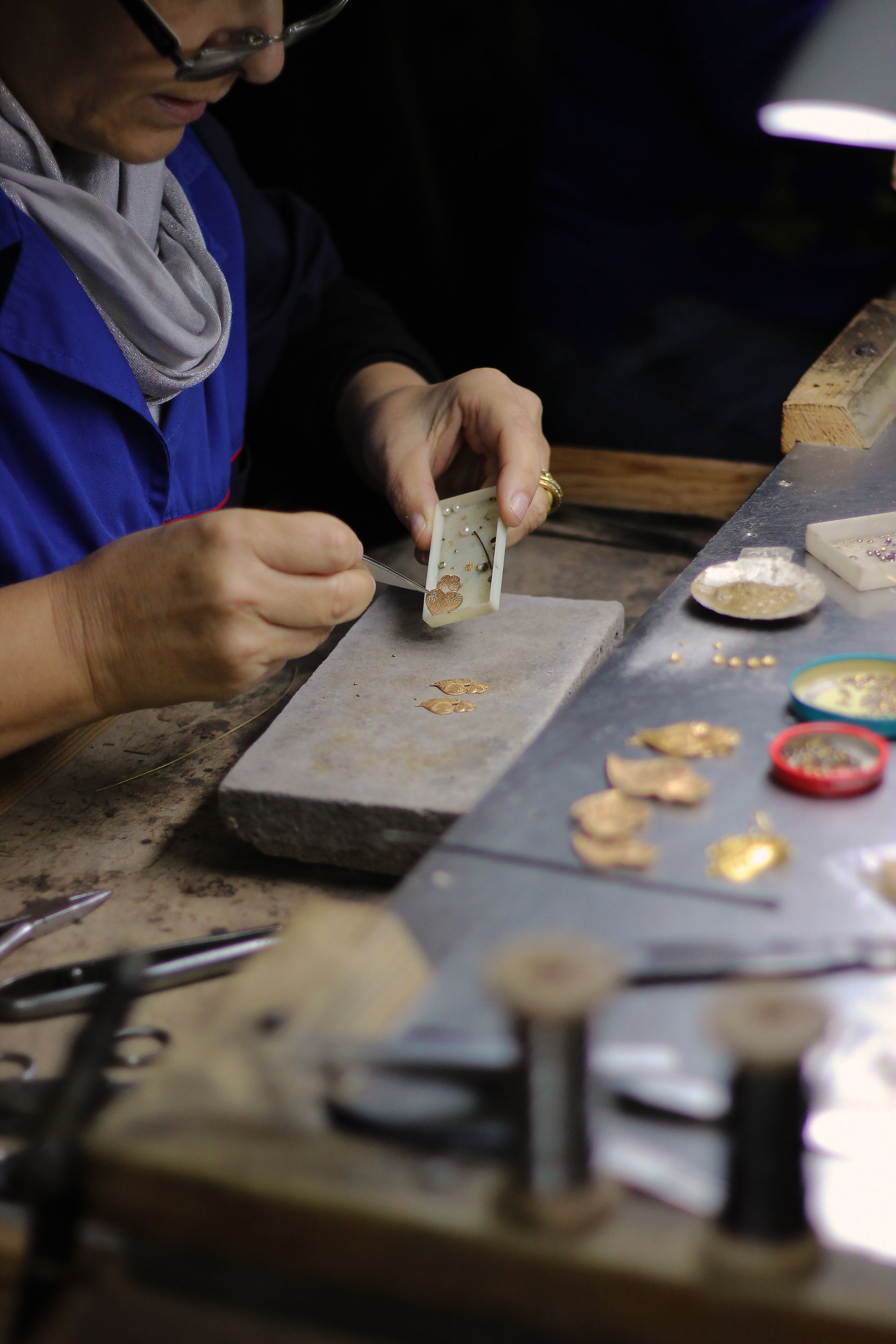 A jewellery maker’s hands working with tools at the bench